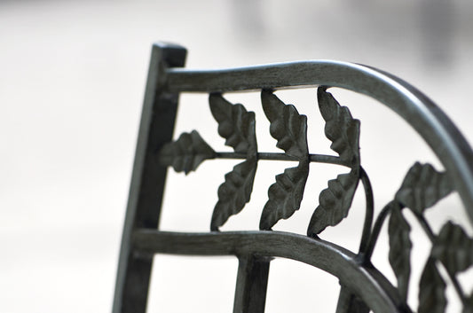 Back of a metal chair with a leaf design